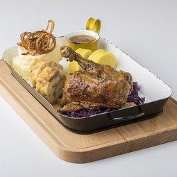 Roasted duck with rosemary and apples, served with red cabbage and an assortment of Czech dumplings